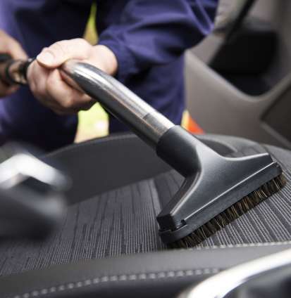 man-hoovering-seat-of-car-during-car-cleaning-royalty-free-image-1585677173