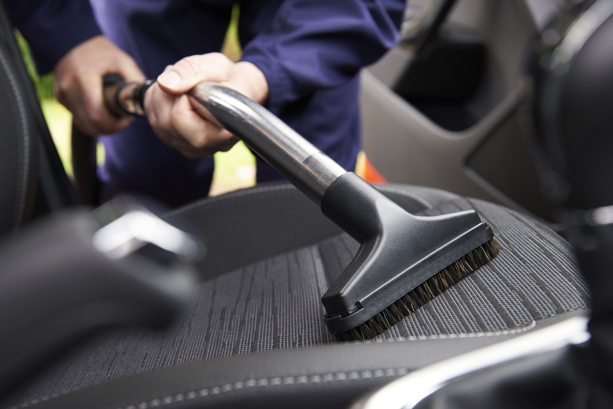 man-hoovering-seat-of-car-during-car-cleaning-royalty-free-image-1585677173